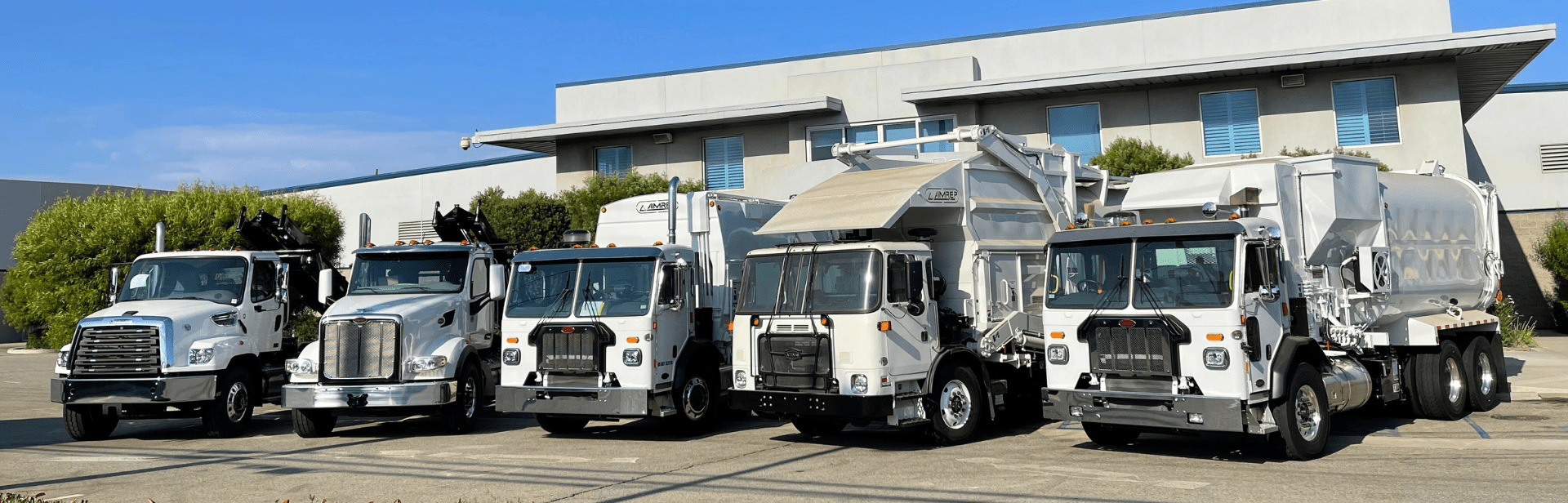 refuse trucks lined up outside wastebuilt facility